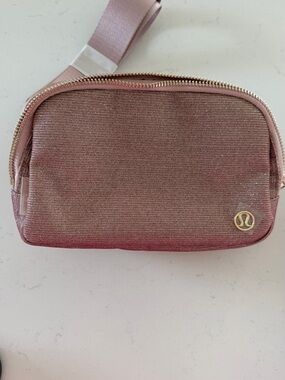 Lululemon Everywhere Belt Bag in a shimmering pink NWT